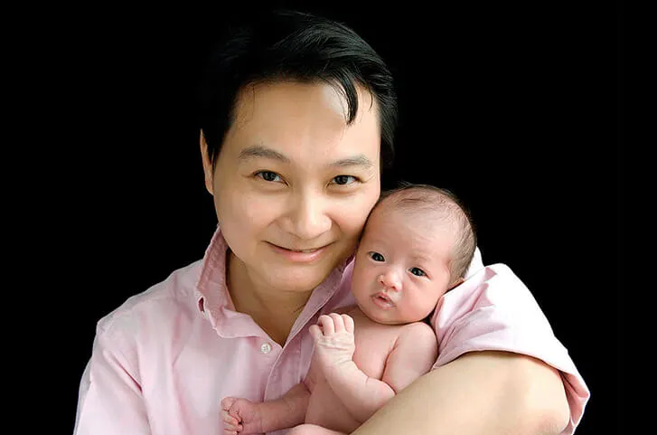 Dr Christopher Ng with a newborn baby
