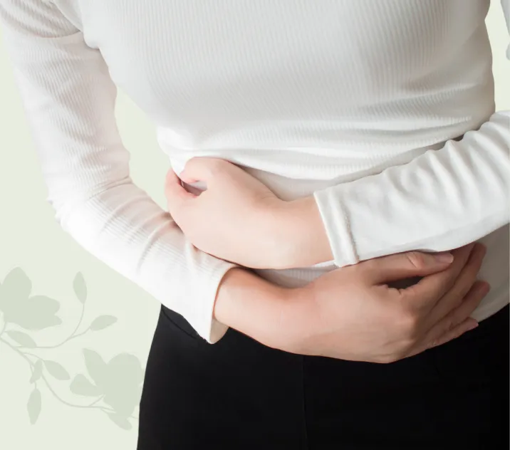 A woman holding her stomach in discomfort