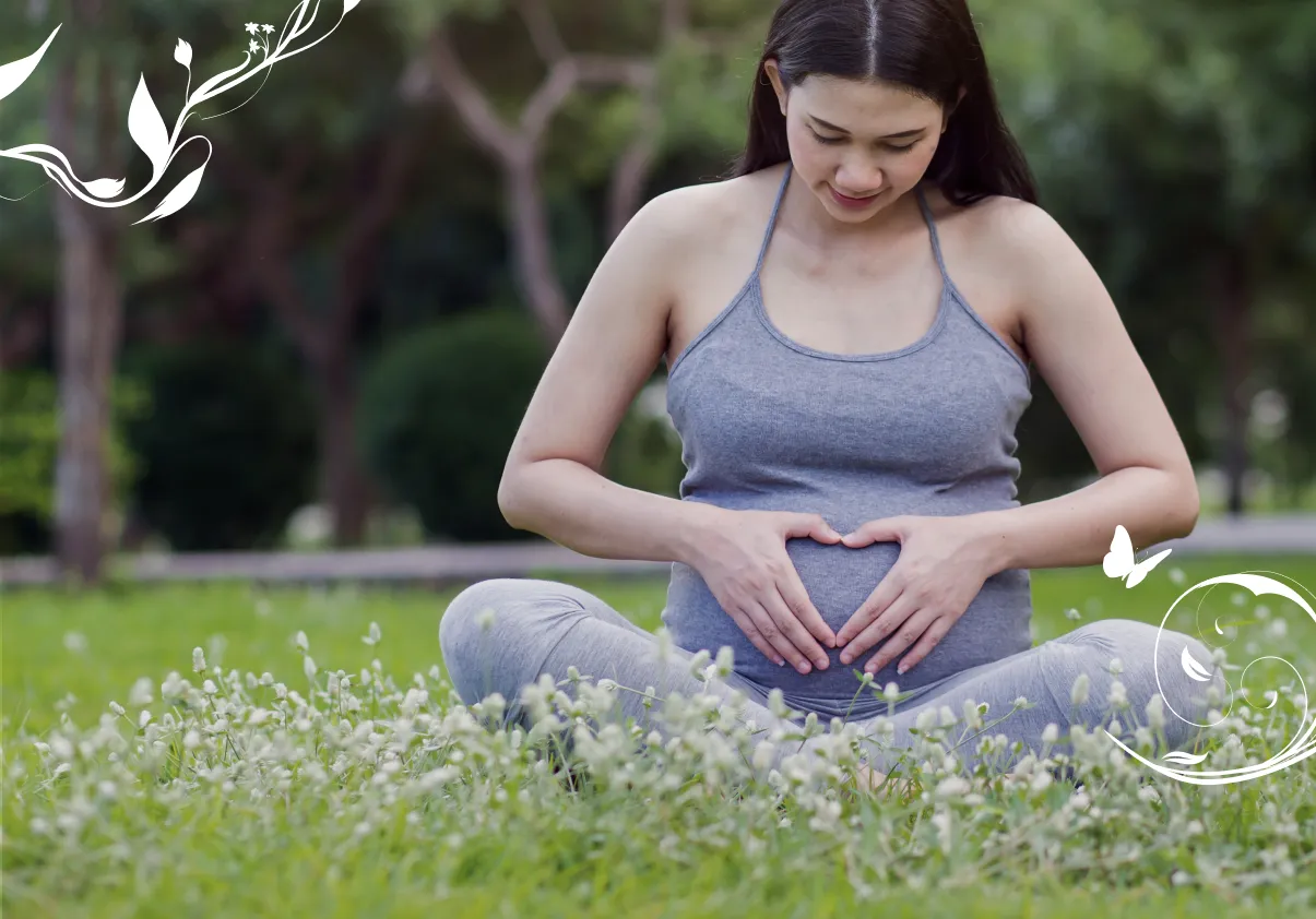 Pregnant woman sitting in a park signifying  obstetrics.